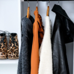 closet of hanging sweaters and jacket