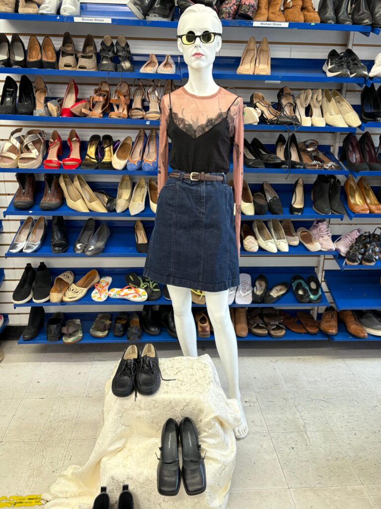back to school black tank top, jean skirt, and red sheer long sleeve on a mannequin