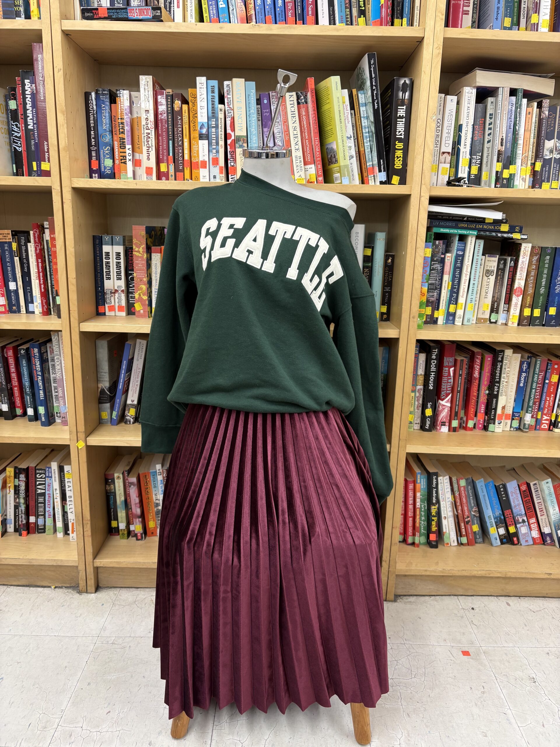 seattle sweater and red pleaded skirt