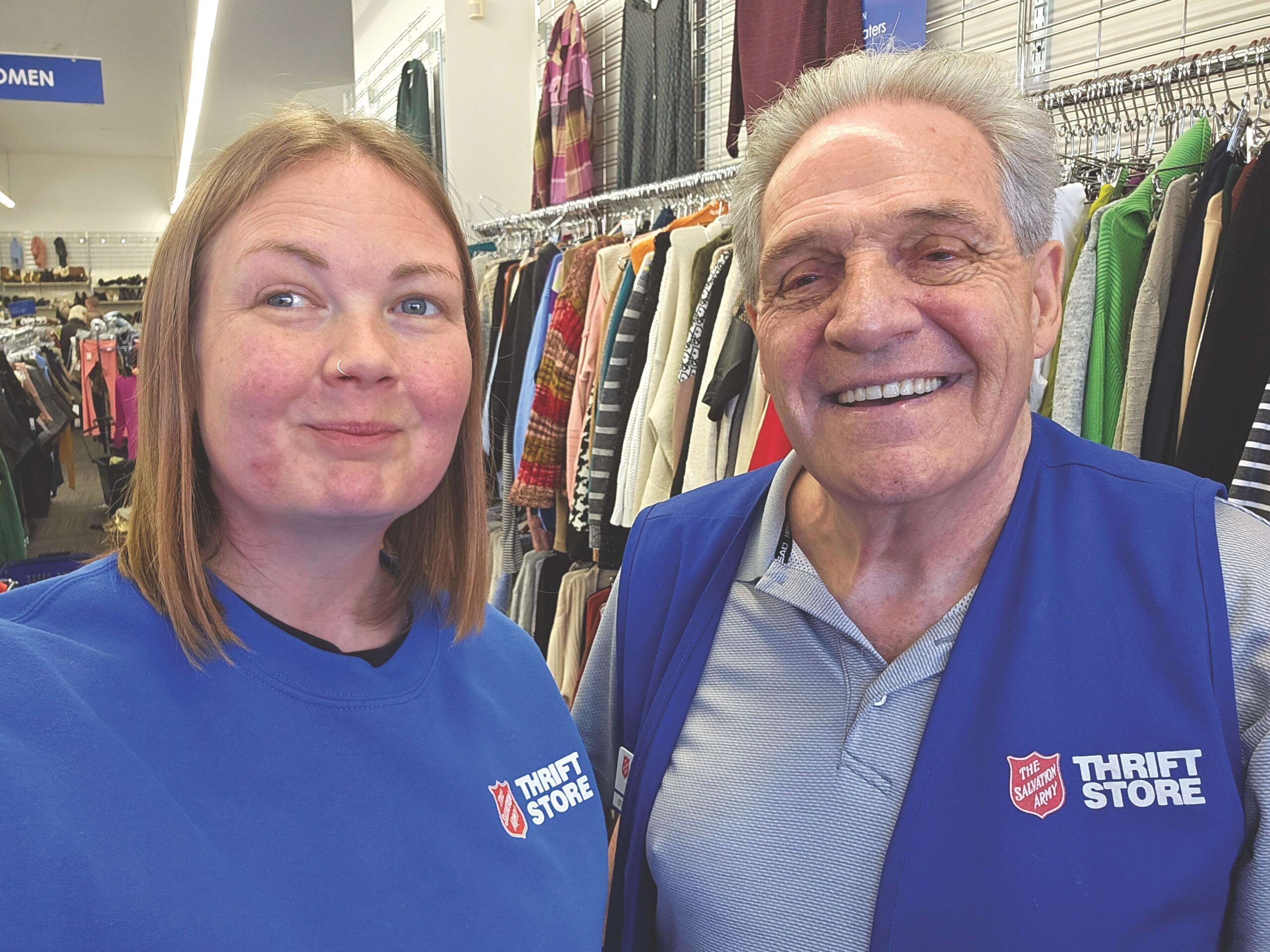 Bill Lewis smiling beside female coworker