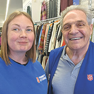 Bill Lewis smiling beside female coworker