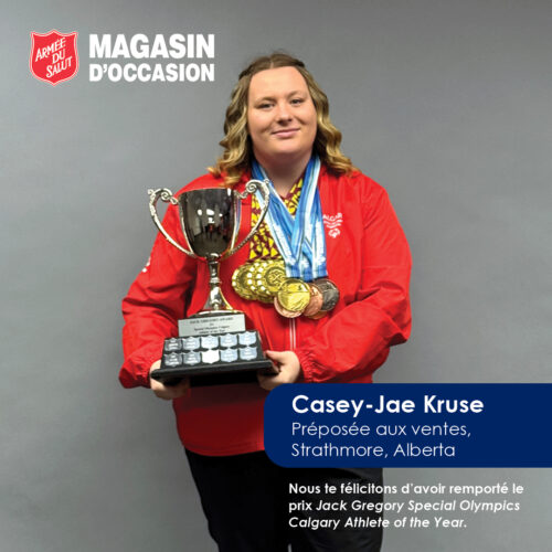 Casey smiling holding a trophy